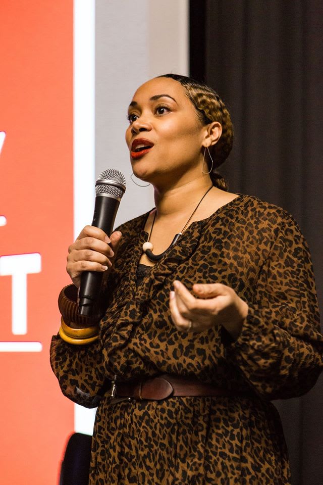 Woman speaking into a microphone