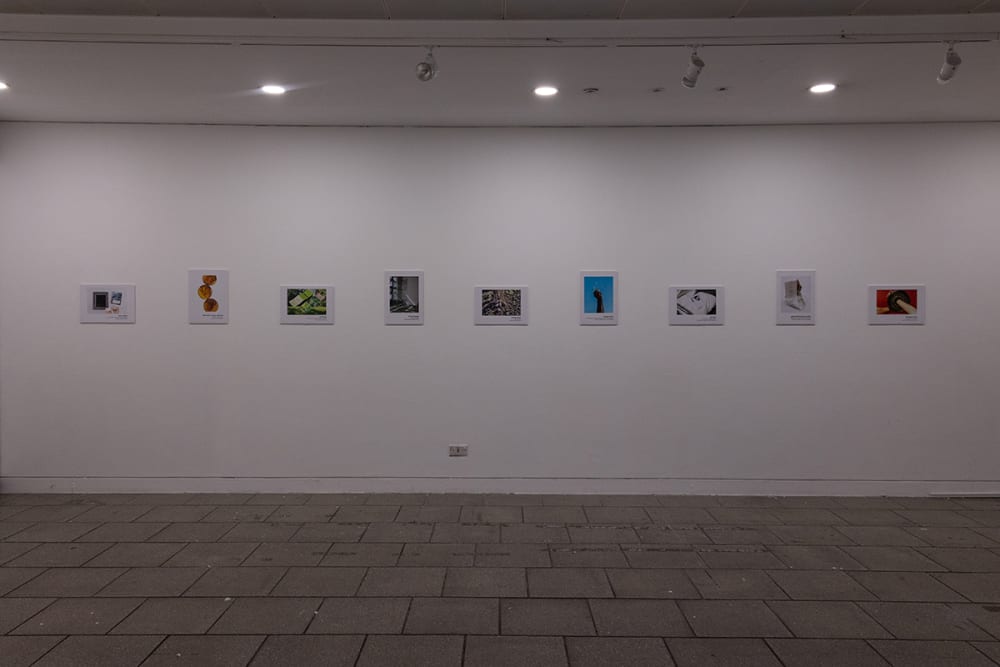photo exhibition installed on white wall