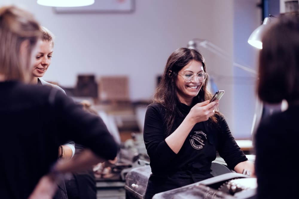 Woman takes a photo of her work 