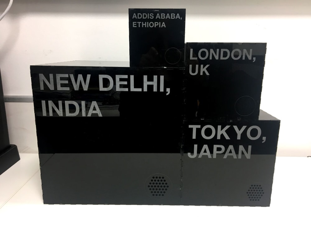 black cubes stacked with names of cities