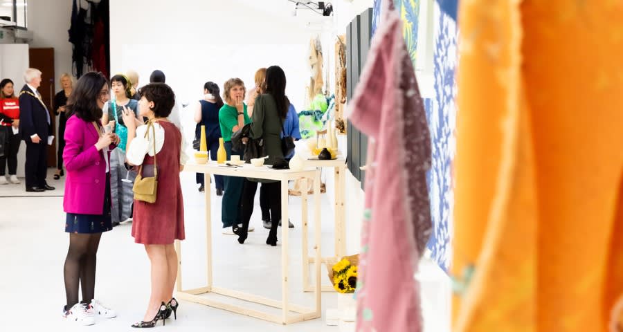 People in a gallery talking and socialising
