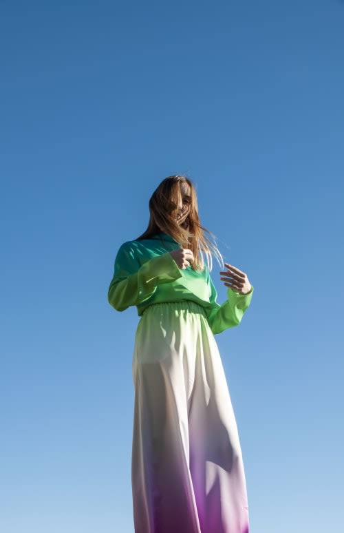 photo of Diane Wallinger in a multicoloured green, white and purple garment