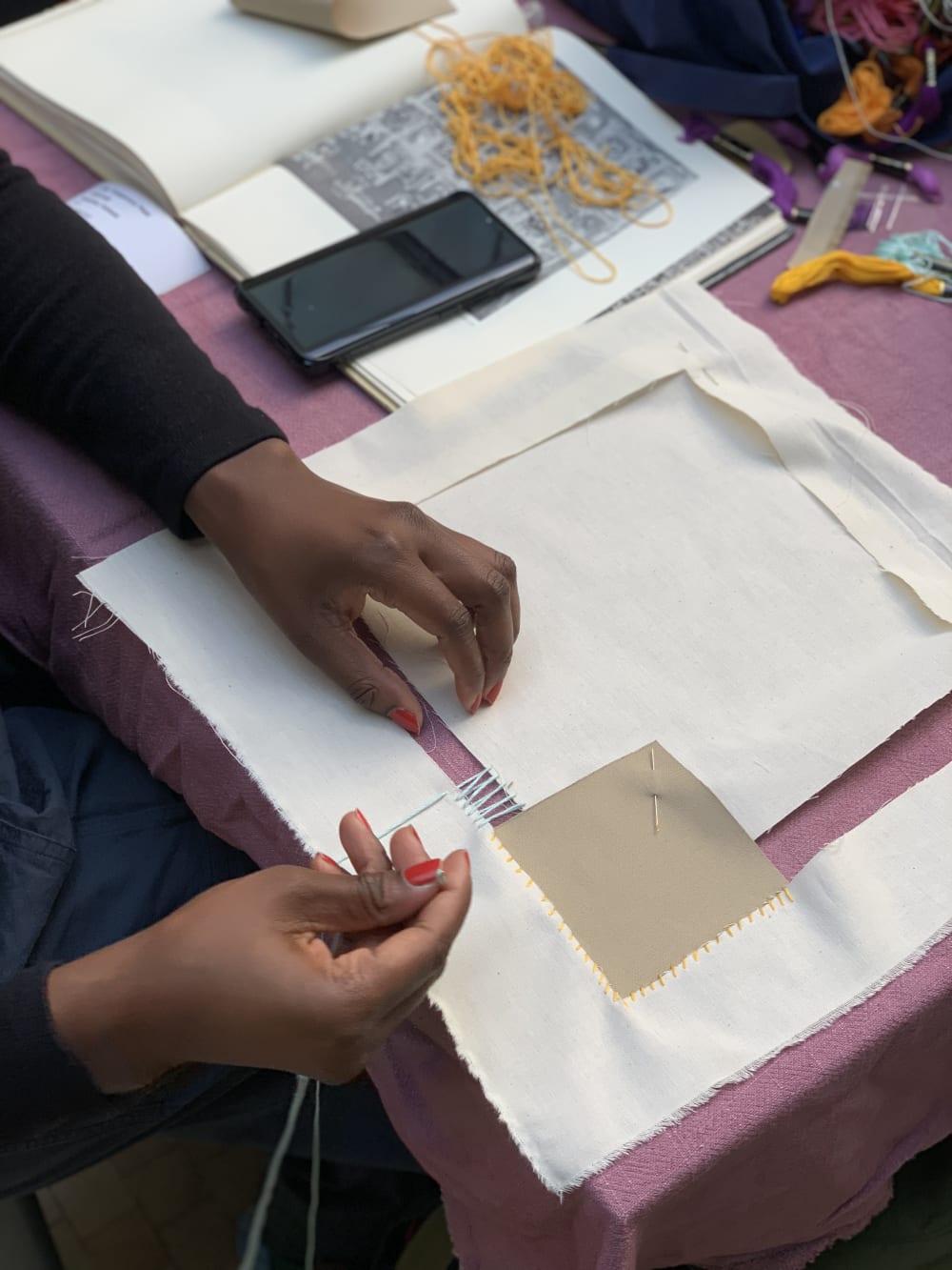 a person stitching two pieces of fabric together