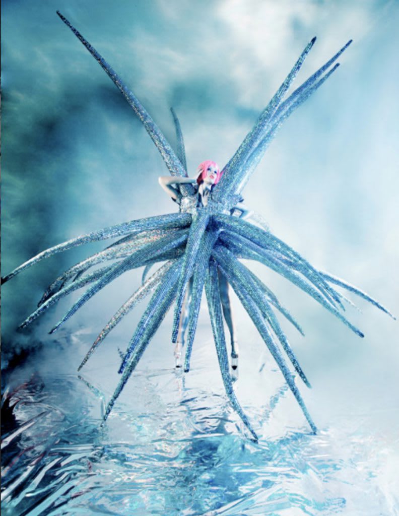 a toy doll modelling an abstract, spiked blue outfit