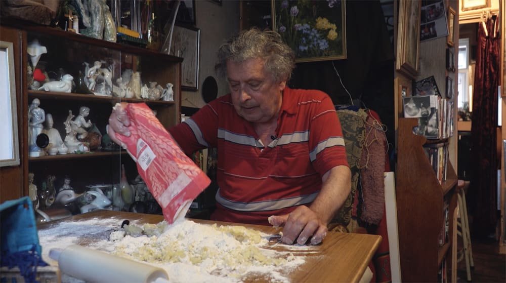 Film still of a man baking.