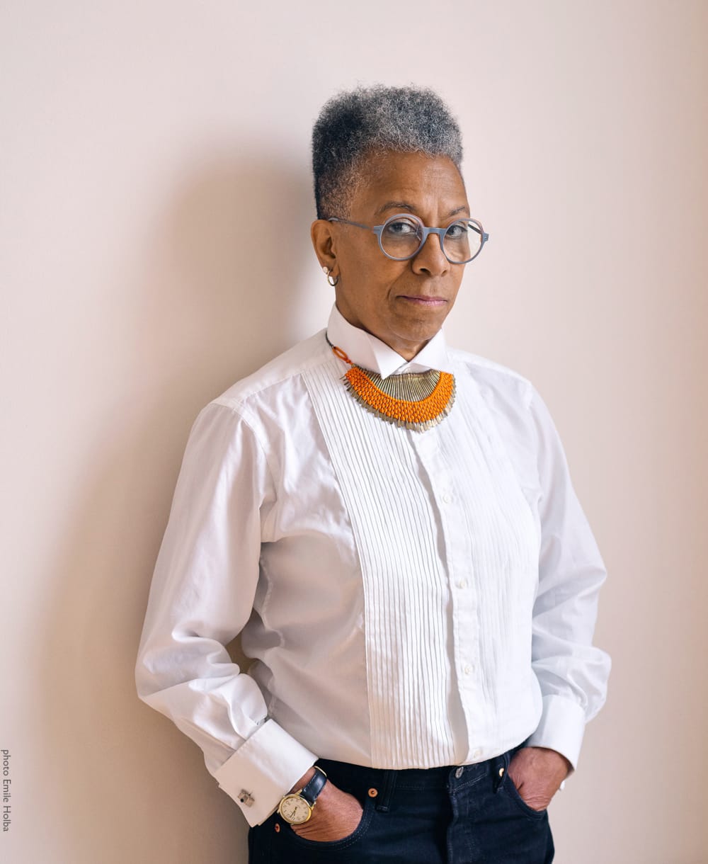 Ingrid Pollard wearing a white shirt and glasses