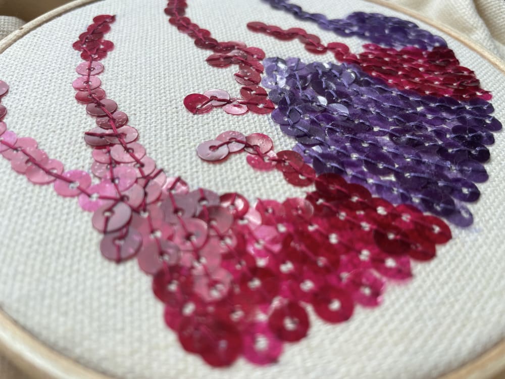Biodegradable sequins in differing shades of pink and purple