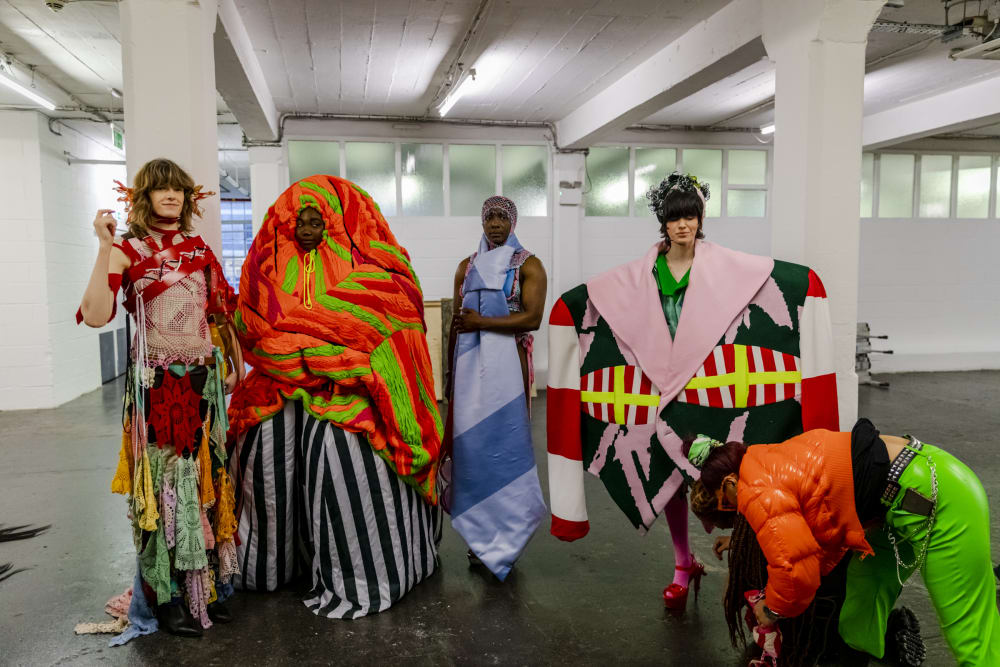 5 models standing in colourful outfits