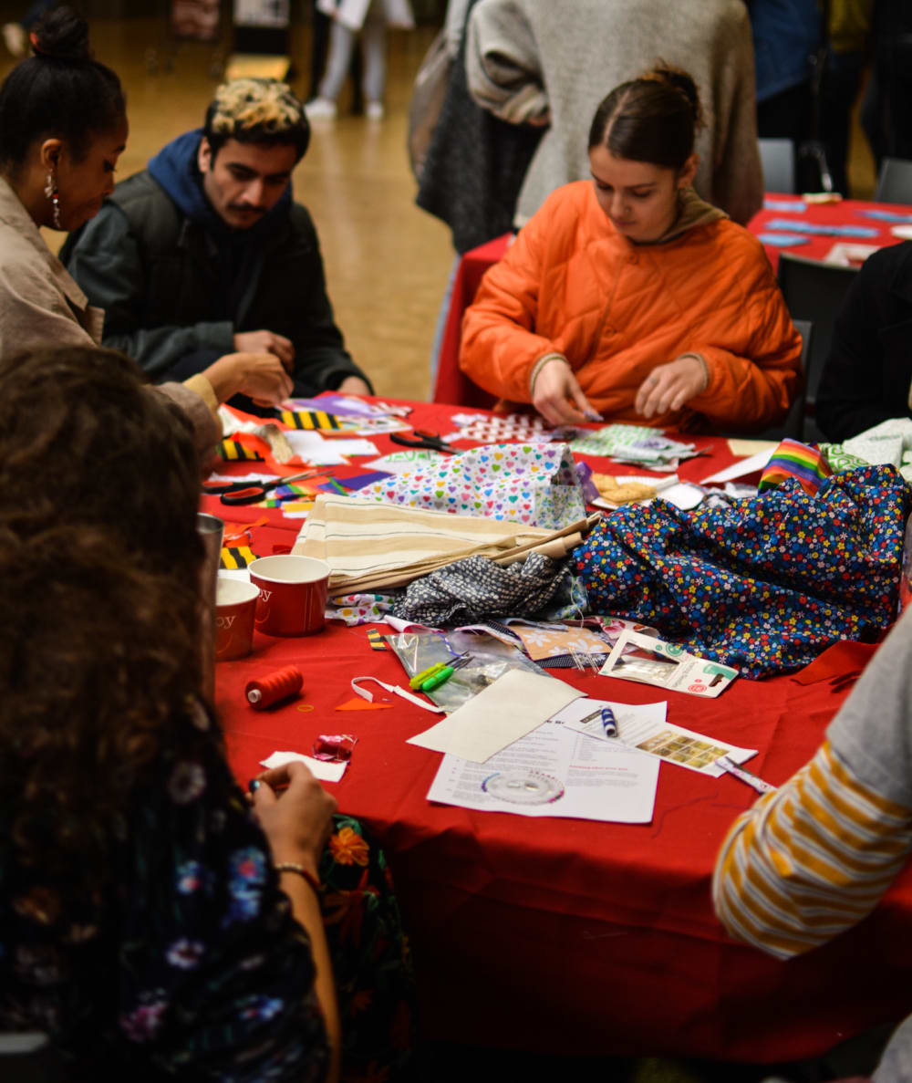 a group of students cutting fabric