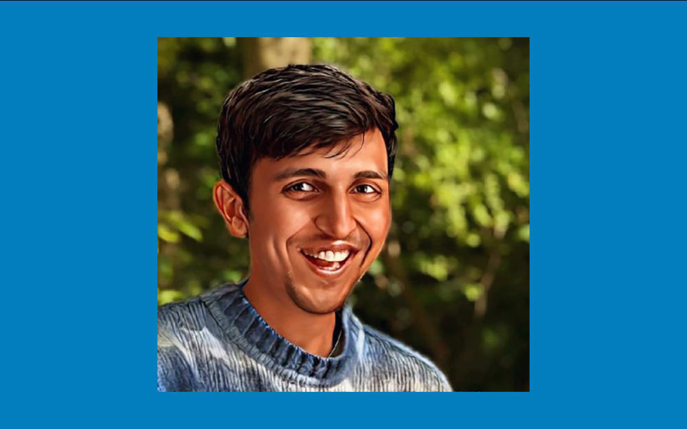 Photograph of a person smiling at the camera.