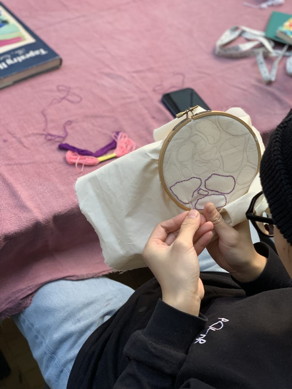 a person embroidering