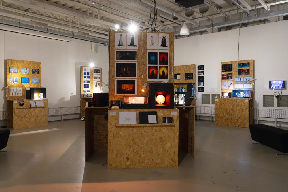 An installation shot of various models and artwork