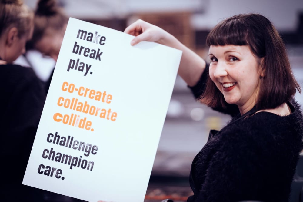 Woman holds up her poster