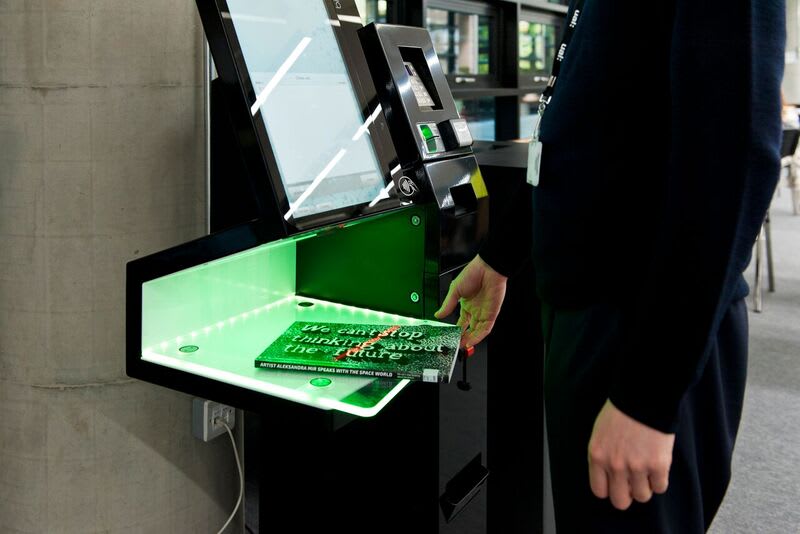 Student scanning a book on a borrowing machine