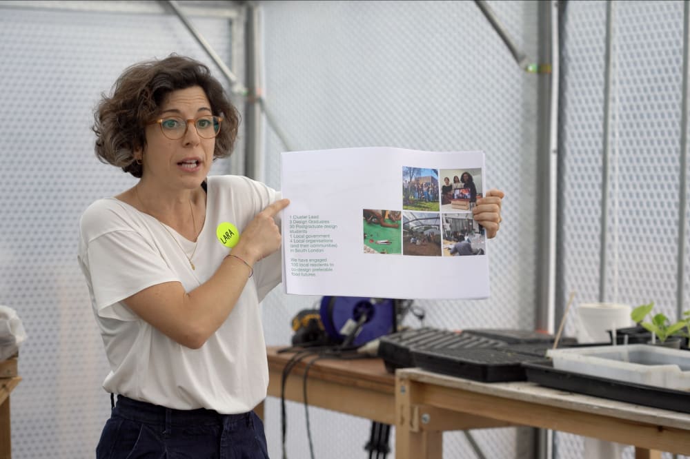 Dr Lara Salinas holding up a piece of paper while explaining an activity