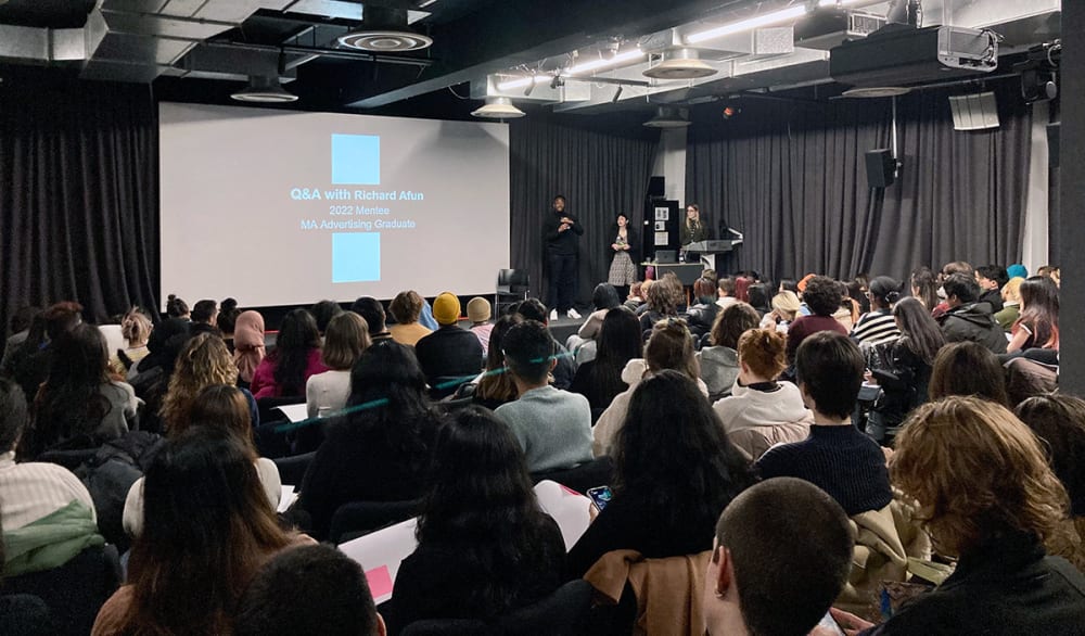 A photograph of someone giving a lecture at London College of Communication.