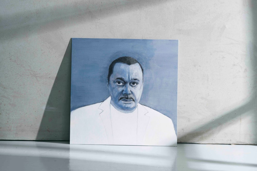 Photograph of a blue-tinted painting of a man propped up against a grey wall.