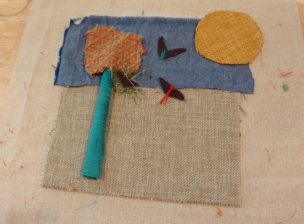 a collage of materials to make a tree with birds flying in the sky