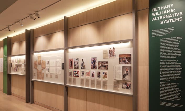 Exhibition display of wall vitrines displaying articles and images