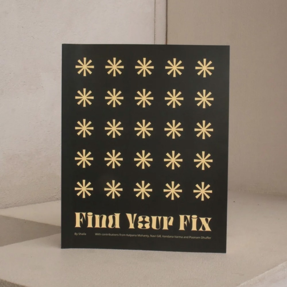 A black book with asterisks and the words Find Your Fix in gold lettering
