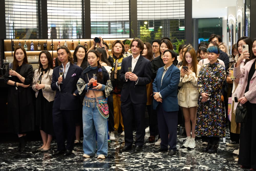 Guests at the reception, standing and clapping