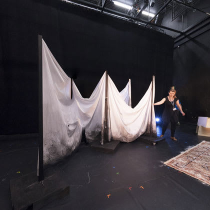 A person setting up backstage at the Studio Theatre at Central Saint Martins