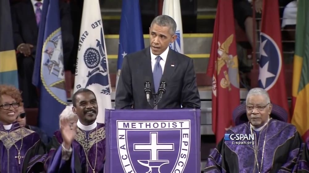 a tv screenshot of barack obama speaking into a microphone