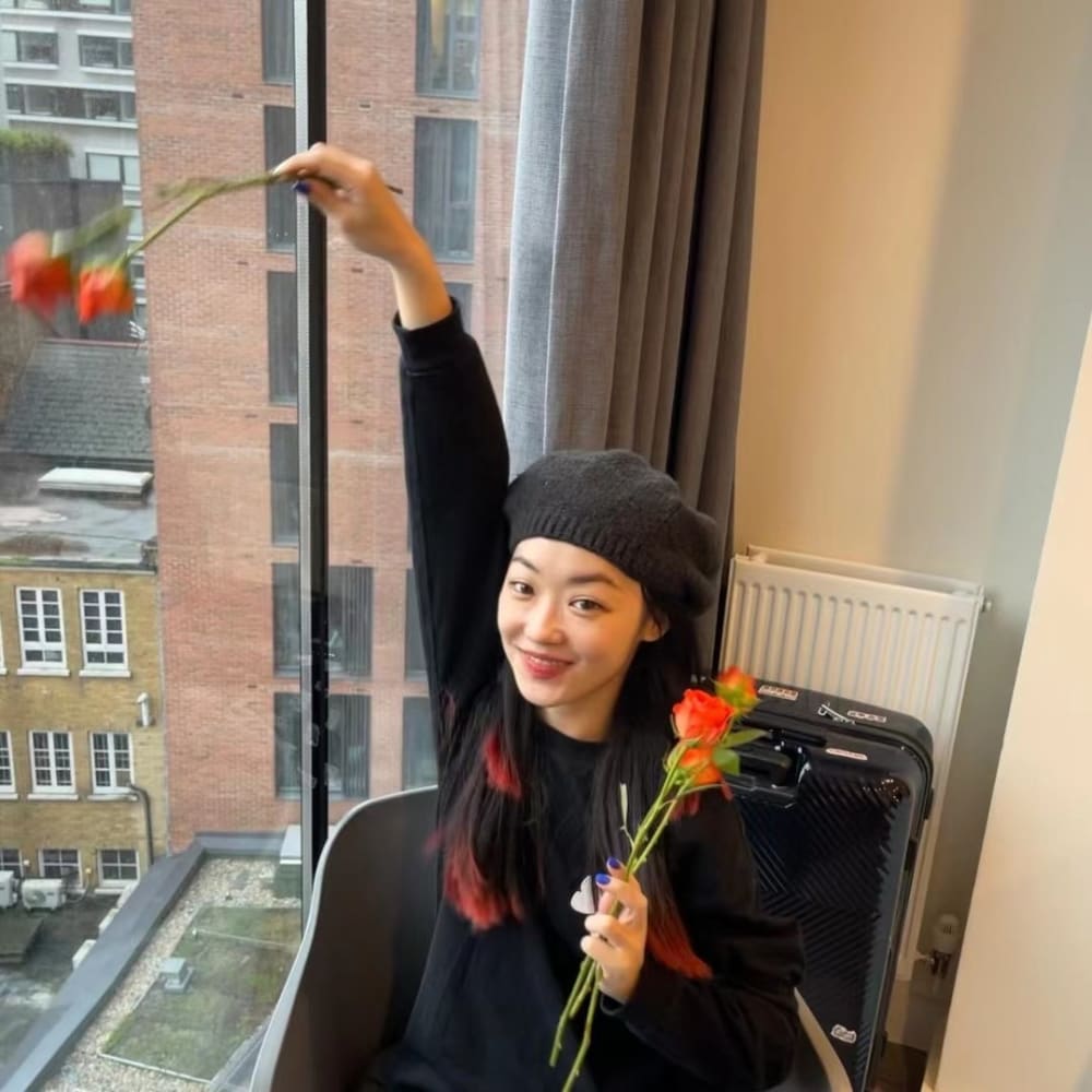 Xinyu standing infront of a painting