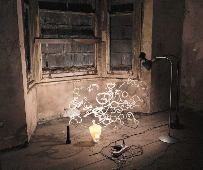 An installation on the floor made out of lights. 