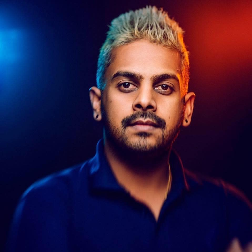 Square photo of a man looking into the camera