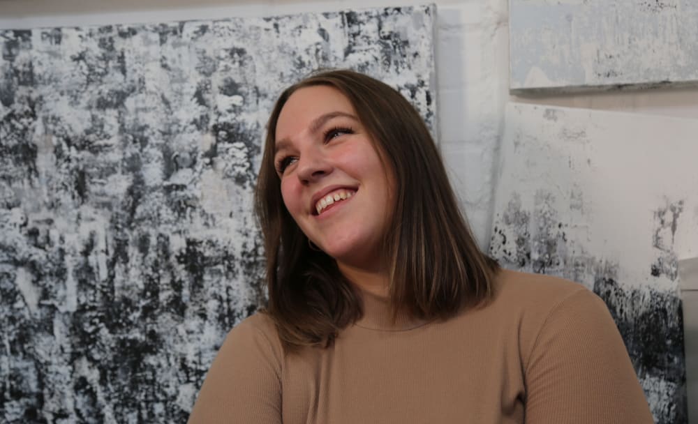 Portrait photograph of a woman smiling.