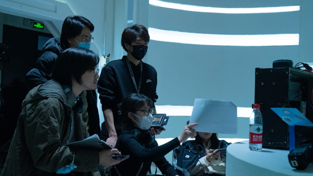 Hazel and crew discussing on set