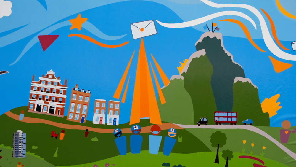 Image shows an envelope, symbolising the gift of life, shining in the sky. Illustrations of doctors and nurses can be seen in the foreground and in the background there are housesand vehicles.
