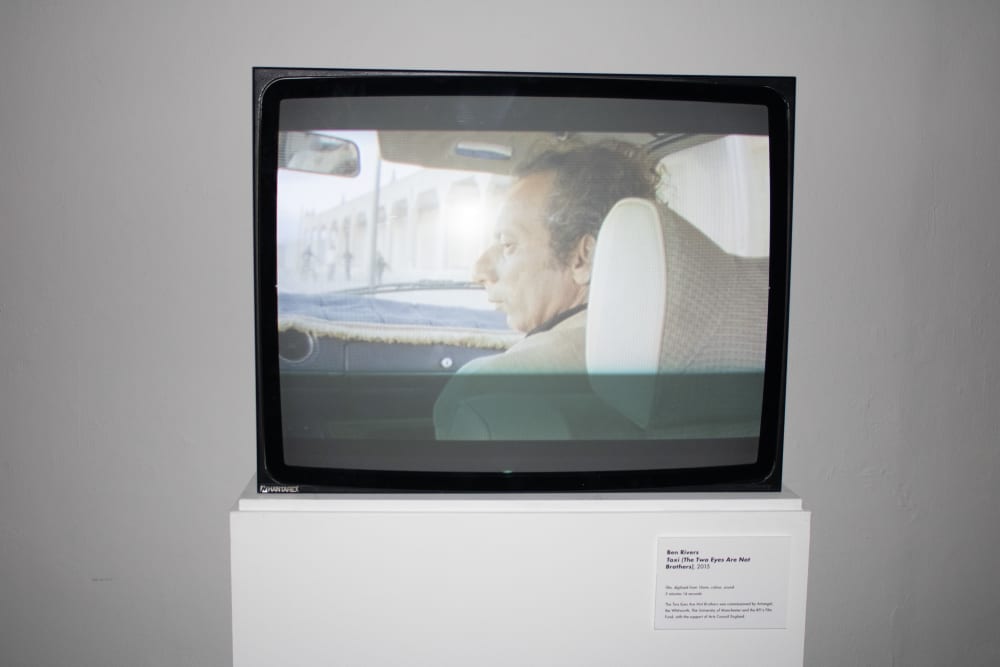 a tv screen showing a man looking to the left