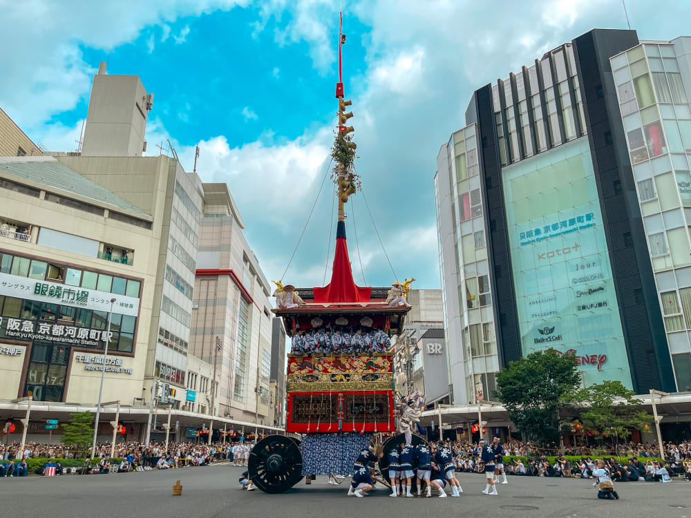 A group of men, trying to move the float to the next street