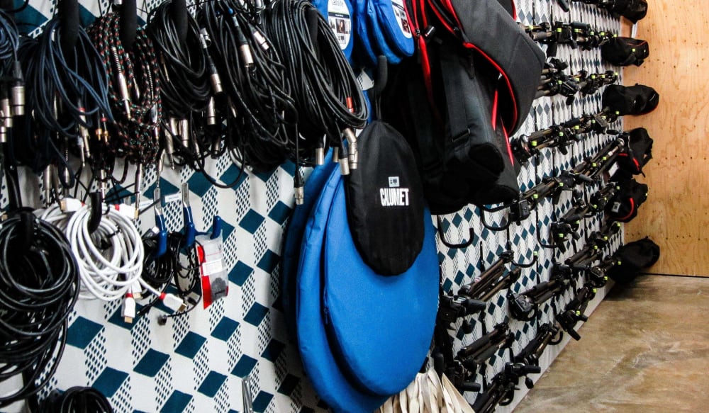 Cables and tripods hung on a wall 