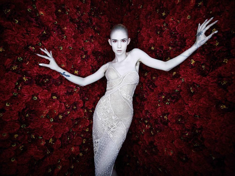 a portrait of a pale woman surrounded by flowers
