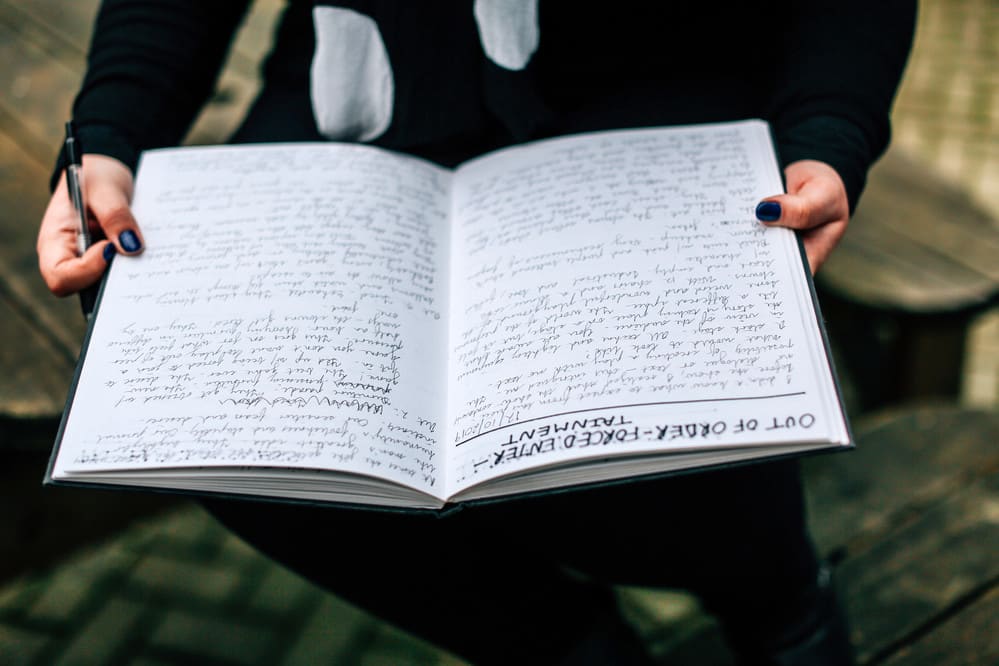 woman reading notebook
