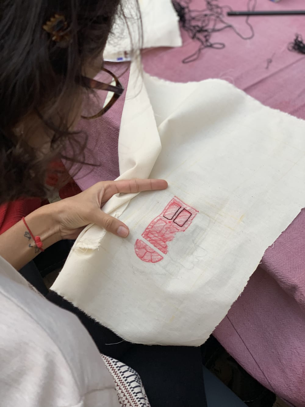 A person embroidering on a piece of fabric