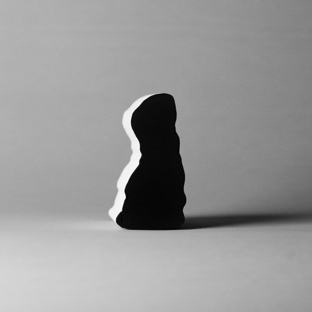 obscure black shape with shadow in greyscale