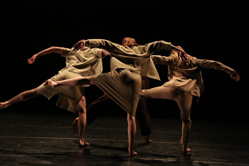 A behind shot of three women doing synchronized dancing