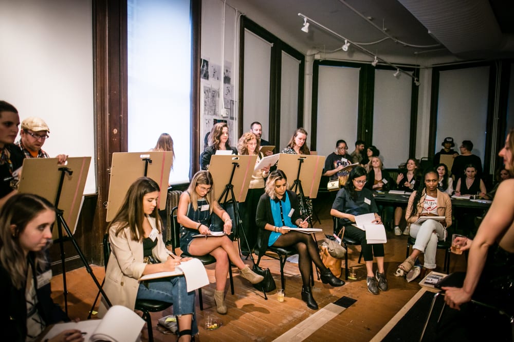 People taking part in a life drawing class