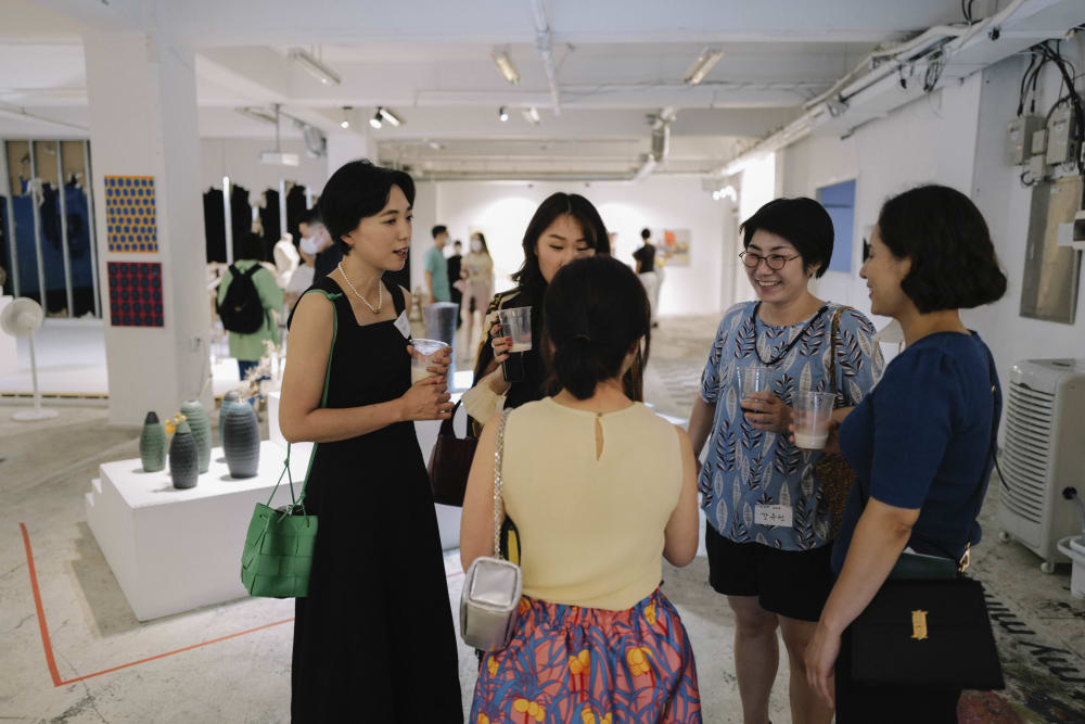 Guests chatting at the exhibition