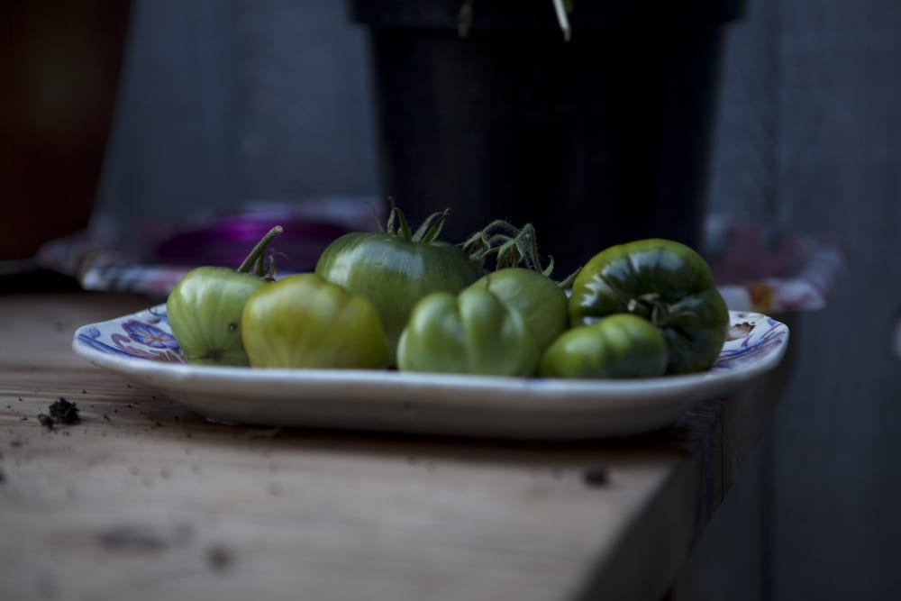 a bowl of green peppers on a table
