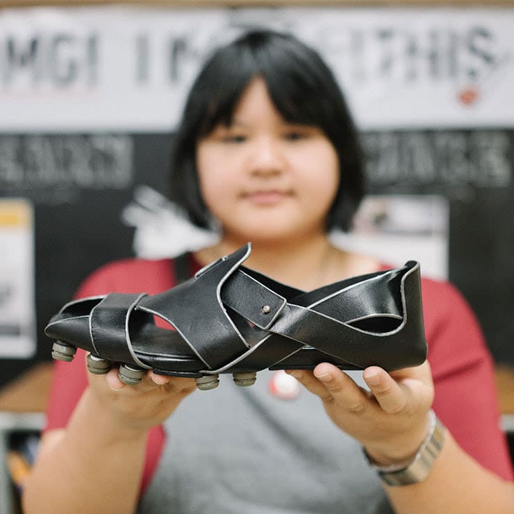 Woman holding a black shoe