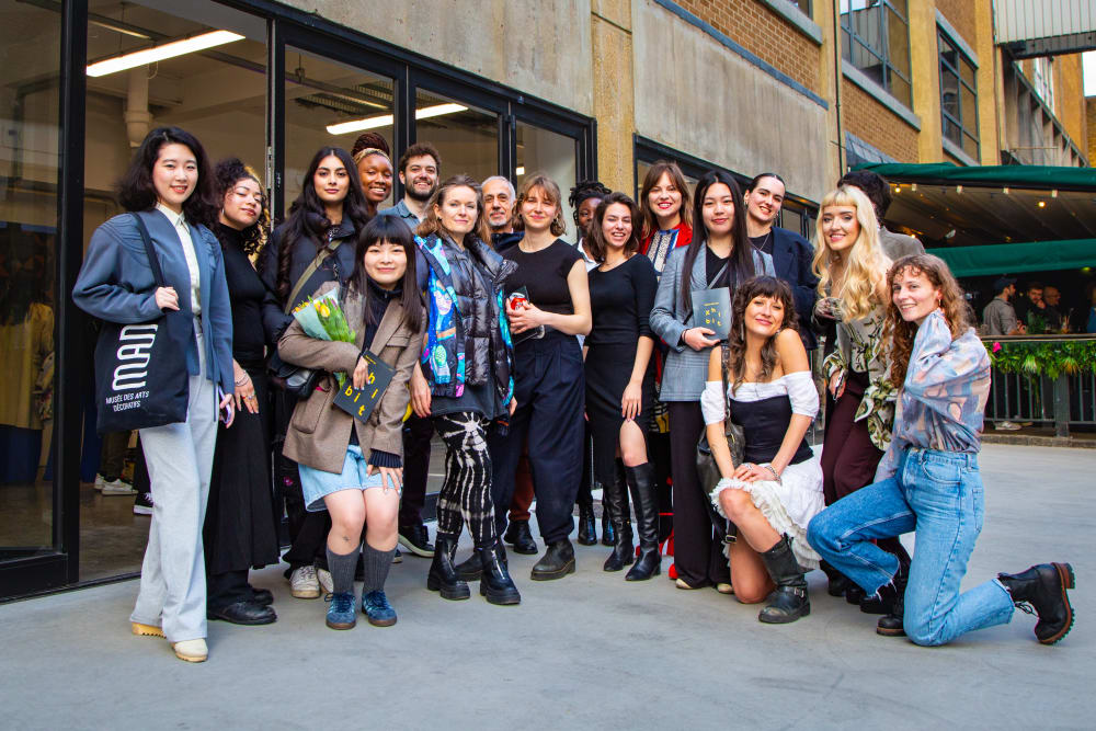 group of students outside a gallery window