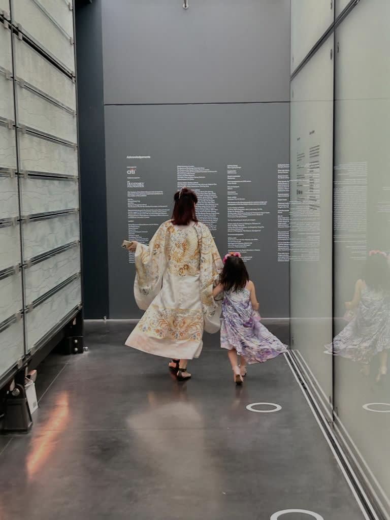 Shot of lady and girl walking from behind at the museum
