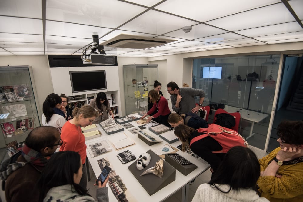a group of students looking at archive materials