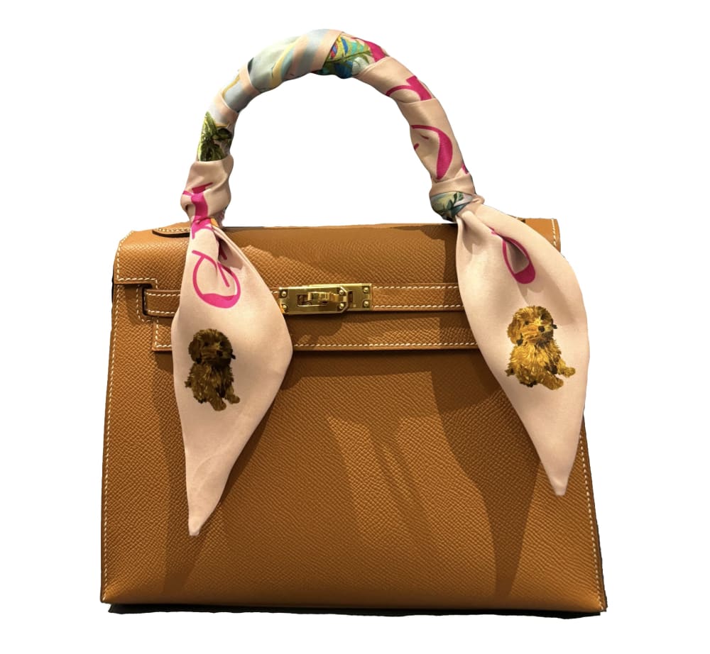 Tan handbag with a Quintet silk scarf around the handle