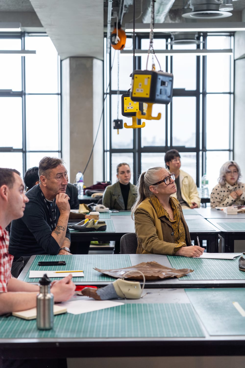 People sat around tables in a classroom.